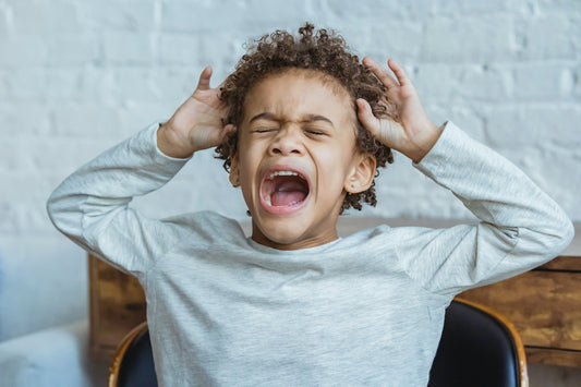 A stressed and anxious child throwing a tantrum. 